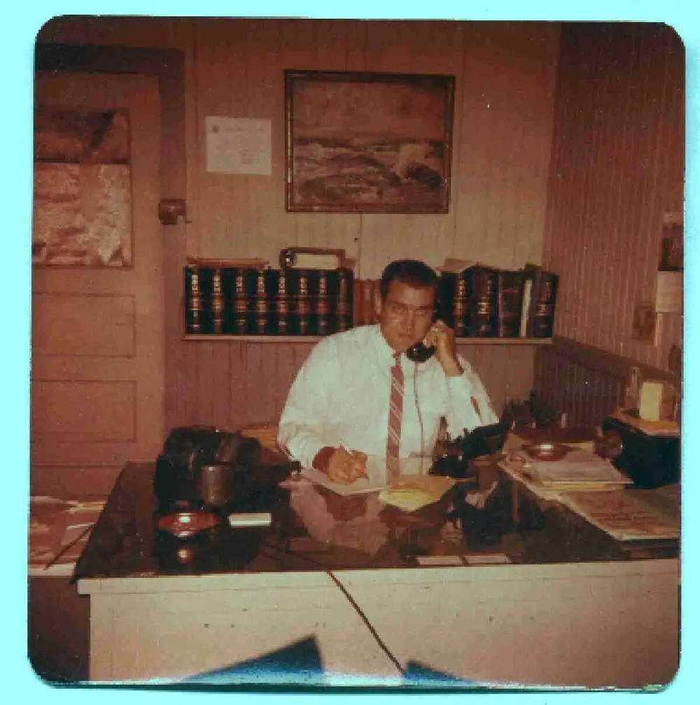 Henry Domzalski Sr. on the telephone at his desk in the Commercial Enterprises office, 1961